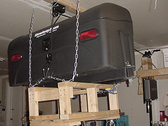 StowAway Standard Cargo Carrier hanging from garage ceiling on pulley system