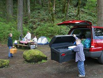 Family at campground; boy unpacking StowAway Standard Cargo Carrier