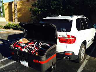 Two golf bags and equipment stored in StowAway MAX Cargo Carrier on BMW X5 SUV