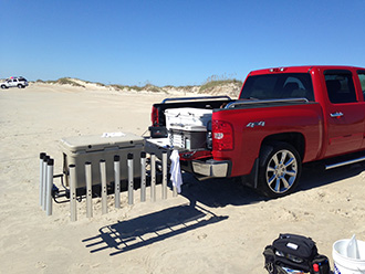 Pickup truck with StowAway Surf Fishing Rod Rack swung out, extra fishing rod holders attached