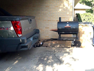 Charcoal grill mounted on StowAway SwingAway frame on Chevy Silverado