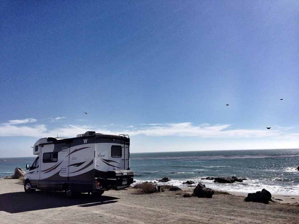 StowAway MAX Cargo Carrier mounted on camper van by the ocean on the California coast
