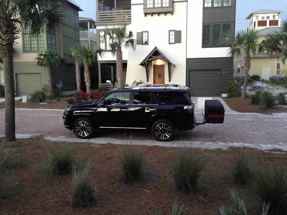 StowAway MAX Cargo Carrier mounted on a black SUV on street in front of house