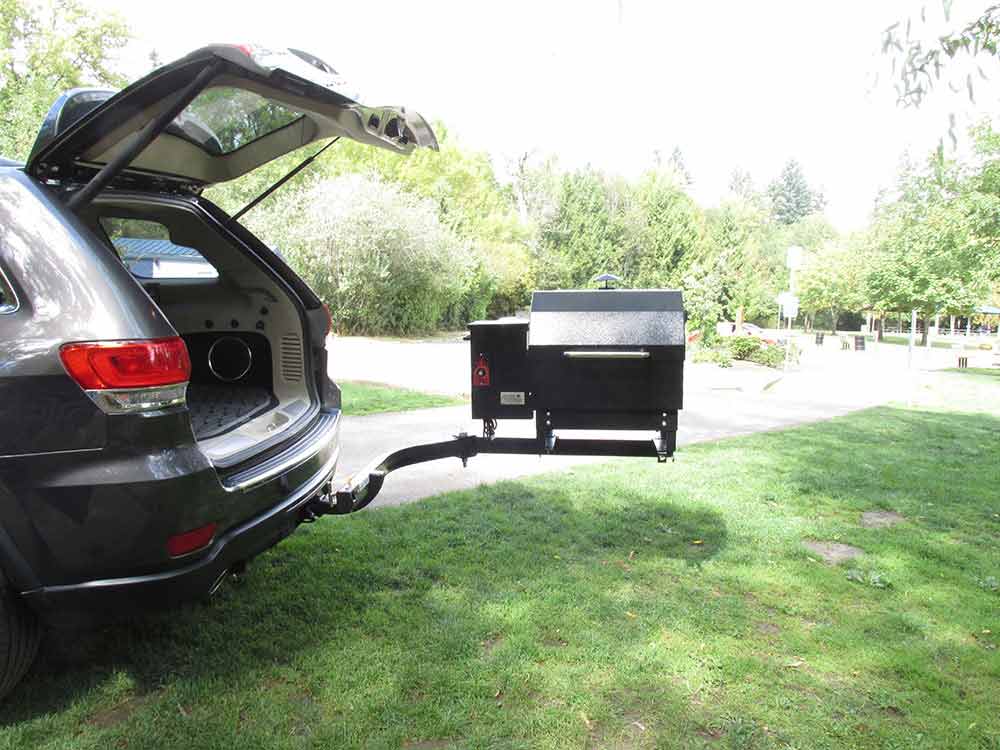 Smokin' Brothers grill attached to a StowAway SwingAway frame with liftgate open and grill swung away