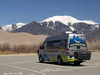 Mountain view behind Mercedes Sprinter van with StowAway MAX Cargo Carrier