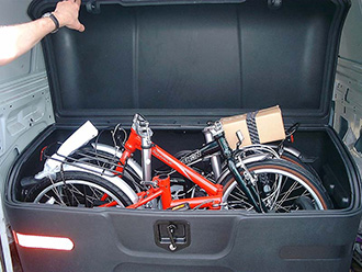 StowAway MAX Cargo Carrier on Chevy Suburban holding 2 folding bikes, open
