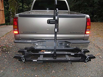 StowAway SwingAway Frame on Chevy Silverado with Thule wheel-mounted bike rack, 2 bikes, SwingAway open