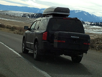 StowAway MAX Cargo Carrier on SUV driving towards the mountains