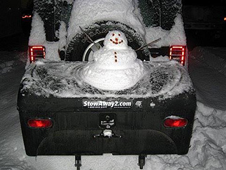 Smiling snowman built on StowAway Standard Cargo Carrier mounted on Jeep Wrangler