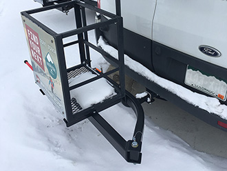 Custom ski/snowboard holder on StowAway SwingAway Frame mounted to Ford Transit 350 van, Winter Park, Colorado