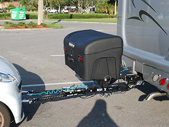 RV towing a car with dual hitch, hitch extender and StowAway Standard Cargo Carrier