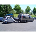 Van using a dual hitch receiver to carry StowAway Standard Cargo Carrier and tow a vehicle